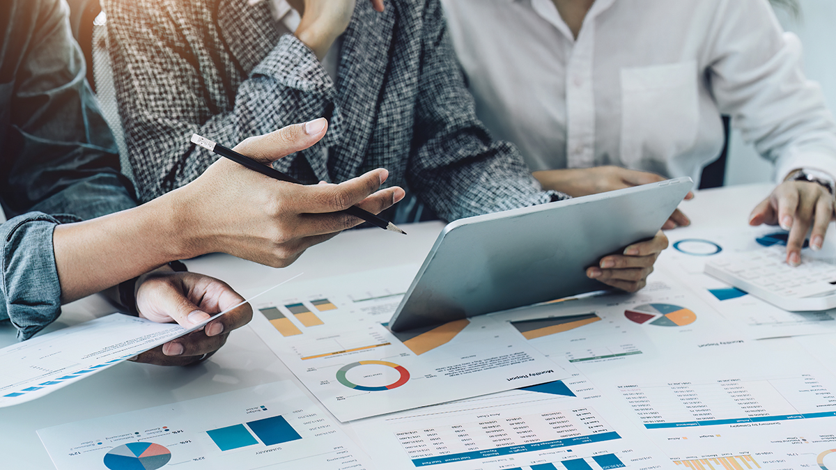 A group of business people working together on a new project to analyze budgets and manage investment risks in today's profit boosting for marketing in the conference room.